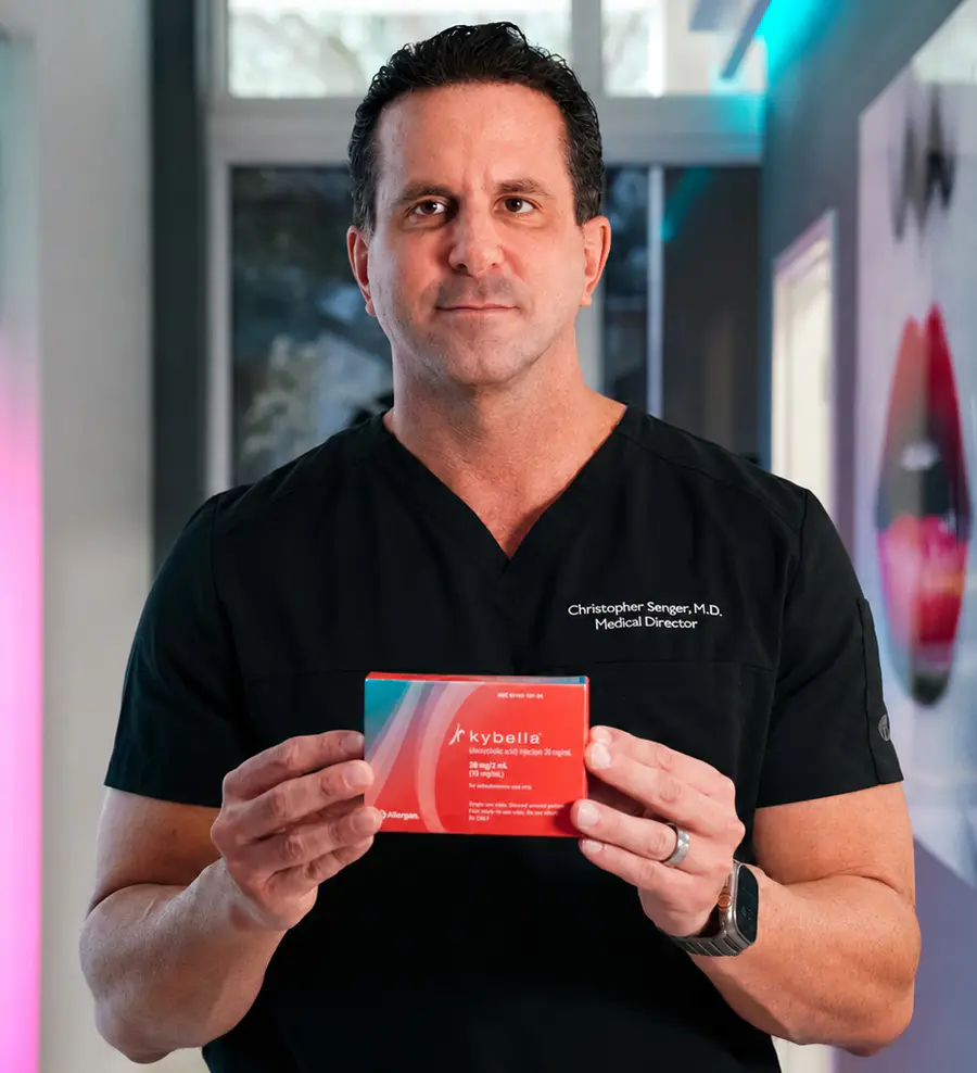 Refresh - Aesthetics & Wellness medical director holding Kybella injectable treatment in a Florida med spa